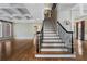 Grand foyer featuring a staircase with black iron railing, hardwood floors and coffered ceilings at 1446 W Wesley Nw Rd, Atlanta, GA 30327