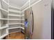 Walk-in pantry with custom shelving and a stainless-steel refrigerator at 1446 W Wesley Nw Rd, Atlanta, GA 30327