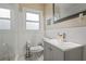 A renovated bathroom with a modern sink, tiled walls, and updated fixtures offers a clean and stylish space at 2132 Penrose Dr, East Point, GA 30344