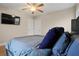 Comfortable bedroom with hardwood floors, ceiling fan, and a wall-mounted TV, offers a peaceful retreat at 2132 Penrose Dr, East Point, GA 30344