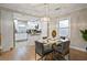 Elegant dining room featuring a glass-top table, modern chandelier, and access to kitchen at 2132 Penrose Dr, East Point, GA 30344