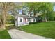 Cozy home with a red door, set in a lush green yard and a tranquil neighborhood at 2132 Penrose Dr, East Point, GA 30344