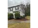 Traditional townhome featuring black shutters, neutral siding, and mature landscaping at 3525 Parc Sw Cir, Atlanta, GA 30311