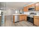 Modern kitchen boasts stainless steel appliances, light countertops, and open access to the spacious living area with modern floors at 3525 Parc Sw Cir, Atlanta, GA 30311