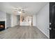 Spacious living room with a cozy fireplace, light gray walls, and modern gray laminate flooring throughout the house at 3525 Parc Sw Cir, Atlanta, GA 30311