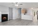 Open-concept living room flows into the kitchen with a cozy fireplace, light gray walls, and modern gray laminate flooring at 3525 Parc Sw Cir, Atlanta, GA 30311