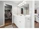 Well-lit bathroom boasting double sinks, cabinetry, and a walk-in closet at 509 Plantation Creek Dr, Loganville, GA 30052