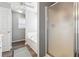 Bright bathroom with a soaking tub, glass shower door, and wood-look floors at 509 Plantation Creek Dr, Loganville, GA 30052