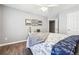 Comfortable bedroom featuring wood floors, a ceiling fan, and decorative wall art at 509 Plantation Creek Dr, Loganville, GA 30052