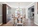 Formal dining room featuring hardwood floors, an elegant chandelier, and large windows at 509 Plantation Creek Dr, Loganville, GA 30052