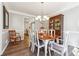 Elegant dining room with a chandelier, hardwood floors, and wainscoting at 509 Plantation Creek Dr, Loganville, GA 30052