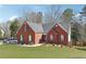 Charming brick home featuring a well-manicured lawn and classic architectural details at 509 Plantation Creek Dr, Loganville, GA 30052