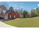 Red brick home with a well-manicured lawn and attached two-car garage at 509 Plantation Creek Dr, Loganville, GA 30052