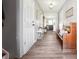 Welcoming hallway featuring wood-look floors, neutral paint, and stylish decor at 509 Plantation Creek Dr, Loganville, GA 30052