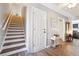 Hallway featuring wood-look floors, neutral paint, and access to stairs at 509 Plantation Creek Dr, Loganville, GA 30052