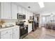 Well-lit kitchen with white cabinets and modern appliances, seamlessly connected to the dining area at 509 Plantation Creek Dr, Loganville, GA 30052