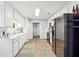 Galley kitchen featuring lots of white cabinets and stainless appliances at 509 Plantation Creek Dr, Loganville, GA 30052
