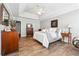 Spacious primary bedroom featuring trey ceilings and hardwood floors at 509 Plantation Creek Dr, Loganville, GA 30052