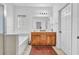 Primary bathroom with double sink vanity, a shower, a large mirror, and tub at 720 Nightwind Way, Stockbridge, GA 30281