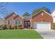 All brick, one-story home with green grass and well maintained landscaping at 720 Nightwind Way, Stockbridge, GA 30281