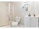 A well-lit bathroom with glass shower doors and a white vanity at 3955 Pucketts Rd, Snellville, GA 30039