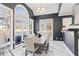 Bright dining area with large windows and a modern chandelier, adjacent to kitchen area at 3955 Pucketts Rd, Snellville, GA 30039