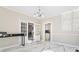 Bright dining area featuring modern lighting, marble floors, and glass-paned doors to other rooms at 3955 Pucketts Rd, Snellville, GA 30039