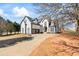 A charming two-story home boasting a well-manicured lawn and driveway at 3955 Pucketts Rd, Snellville, GA 30039