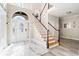 Bright foyer with tile flooring, staircase, and decorative front door at 3955 Pucketts Rd, Snellville, GA 30039