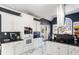 Modern kitchen with stainless steel range hood, granite countertops and sleek white cabinets at 3955 Pucketts Rd, Snellville, GA 30039