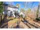 Exterior shot showcasing backyard with pond, deck, patio, and wooded views at 450 Congress Pkwy, Lawrenceville, GA 30044