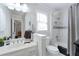 Bright bathroom with a vanity, toilet, and shower-tub combo featuring tiled walls at 450 Congress Pkwy, Lawrenceville, GA 30044