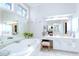 Bright bathroom with a large soaking tub, vanity area, and modern fixtures at 450 Congress Pkwy, Lawrenceville, GA 30044