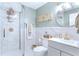 Bright bathroom with frameless glass shower, marble tile, and grey vanity with gold hardware at 450 Congress Pkwy, Lawrenceville, GA 30044