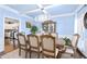 Elegant dining room with light blue walls, coffered ceiling and a large dining table at 450 Congress Pkwy, Lawrenceville, GA 30044