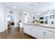 Open concept kitchen with white cabinets, granite countertops, and stainless steel appliances at 450 Congress Pkwy, Lawrenceville, GA 30044