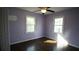 Comfortable bedroom with hardwood floors, ceiling fan, and natural light from two windows at 4681 City View Dr, Forest Park, GA 30297