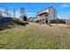 Expansive backyard featuring a well-maintained lawn and a charming two-story home with a deck at 5065 Timberbridge Ln, Johns Creek, GA 30022