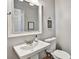 Powder room featuring a modern white sink, toilet, and gray walls with decorative accents at 5065 Timberbridge Ln, Johns Creek, GA 30022