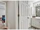 Hallway view of the bathroom, showcasing the vanity with storage and shower at 5065 Timberbridge Ln, Johns Creek, GA 30022