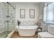 The bathroom features a freestanding tub, a glass shower, and modern decor at 5065 Timberbridge Ln, Johns Creek, GA 30022