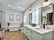 This bathroom boasts double sinks, modern fixtures, soaking tub and a separate glass shower at 5065 Timberbridge Ln, Johns Creek, GA 30022