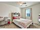 Bright bedroom features a large window, a patterned bedspread, and a stylish desk at 5065 Timberbridge Ln, Johns Creek, GA 30022