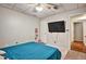 Bedroom with a plush pink rug and mounted TV at 5065 Timberbridge Ln, Johns Creek, GA 30022