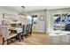 Bright dining room features wood floors, a modern light fixture and sliding glass doors to the deck at 5065 Timberbridge Ln, Johns Creek, GA 30022