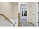 Second floor hallway with carpeted floor, white walls and doors, and a staircase with dark iron spindles at 5065 Timberbridge Ln, Johns Creek, GA 30022