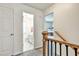 Upstairs hallway with views of the bathroom and bedroom featuring a staircase with wood and iron handrail at 5065 Timberbridge Ln, Johns Creek, GA 30022