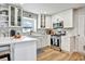 White kitchen featuring stainless appliances, breakfast bar, and stylish backsplash at 5065 Timberbridge Ln, Johns Creek, GA 30022