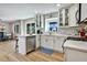 This all-white kitchen features stainless steel appliances and a breakfast bar overlooking the dining area at 5065 Timberbridge Ln, Johns Creek, GA 30022