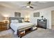 Comfortable main bedroom featuring a ceiling fan, carpet floors, and a decorative accent wall at 5065 Timberbridge Ln, Johns Creek, GA 30022